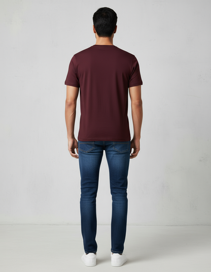 Back view of dark-toned Tamil Nadu model wearing maroon T-shirt with jeans
